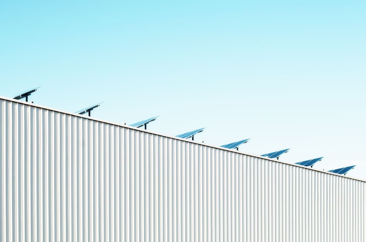 Captadores solares instalados en el tejado de un edificio terciario, ilustrando el acoplamiento fotovoltaico-térmico para la climatización solar