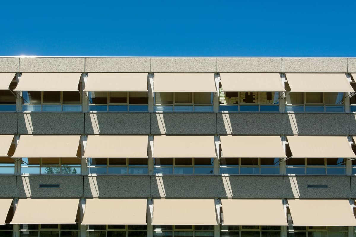Modern building facade equipped with a sun shade to protect against the summer heat