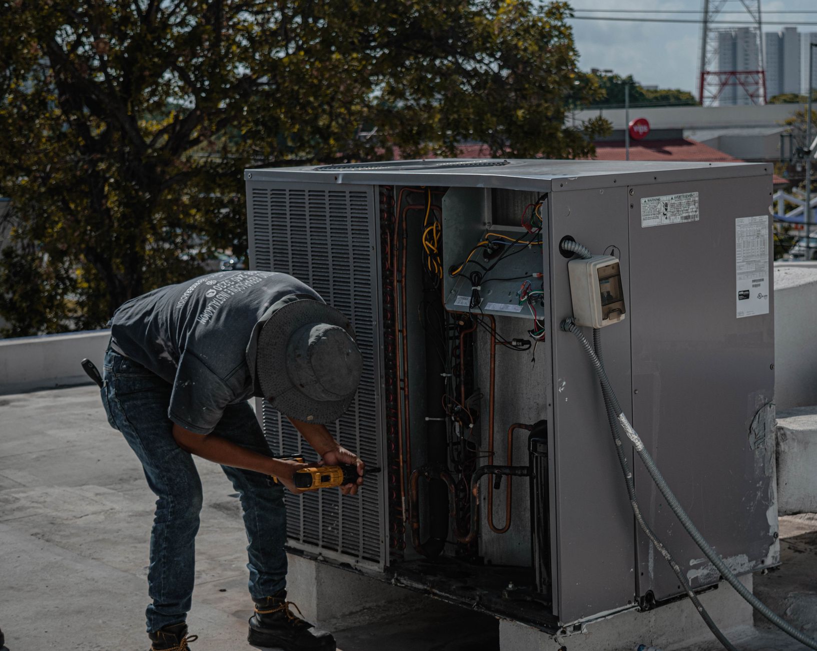 Technician checking the seal of an air conditioning unit